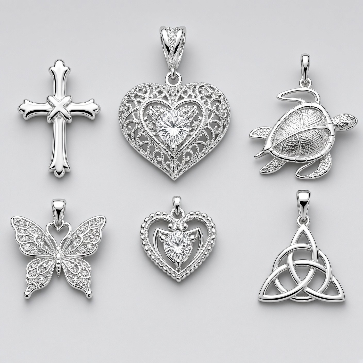 Sterling silver charms and pendants, including hearts, crosses, and animals